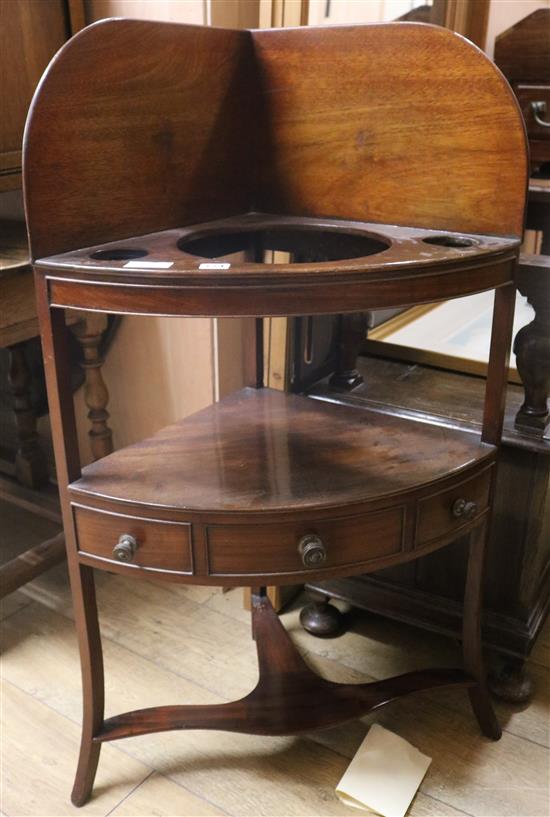A George III mahogany bowfronted two tier corner washstand